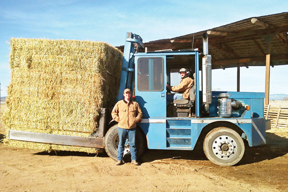 Nick and Sam Moxley moving hay