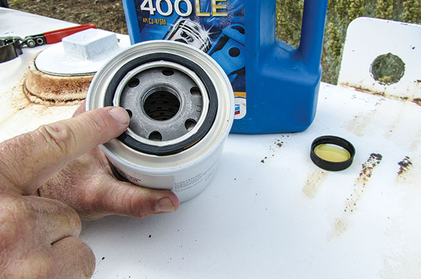 A thin coat of of clean motor oil is applied to the fuel filter gasket
