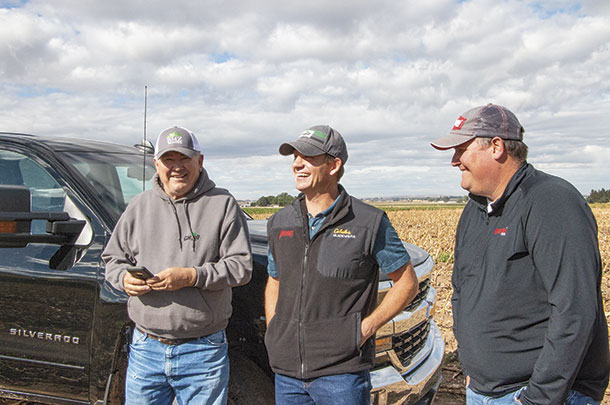 Ray Robinson consults with Cargill nutritionist Shane Holt and Mycogen agronomist Eric Frasure to discuss next steps in feed management. 